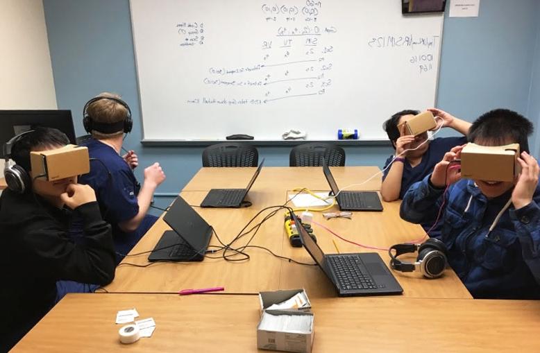 Students testing out the VR headsets in a classroom.