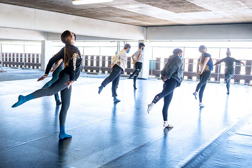 菠菜网lol正规平台 dancers mid-dance in the parking garage.